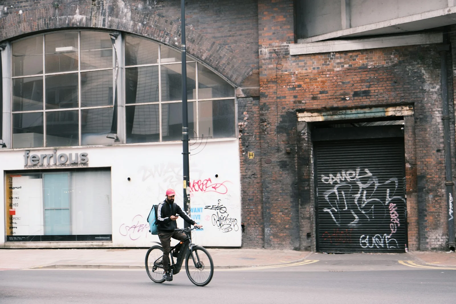 man in black jacket riding bicycle on road during daytime